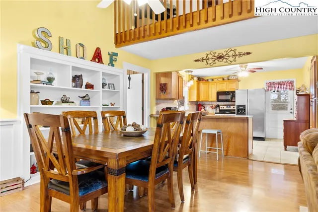 a dining table with chairs and kitchen view