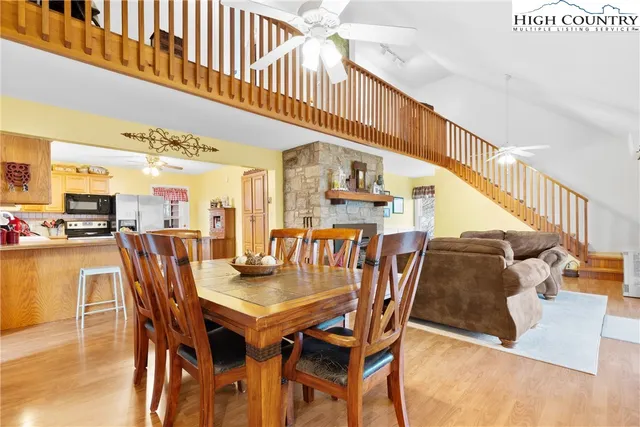 a dining room with furniture window and wooden floor