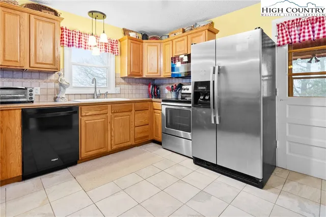 a kitchen with stainless steel appliances granite countertop a refrigerator sink and cabinets