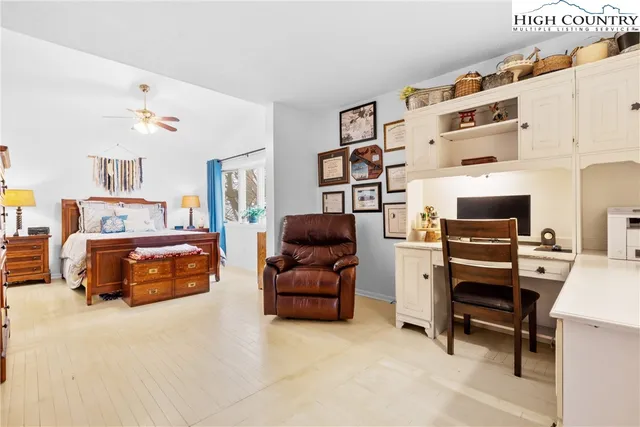 a bedroom with furniture and a book shelf
