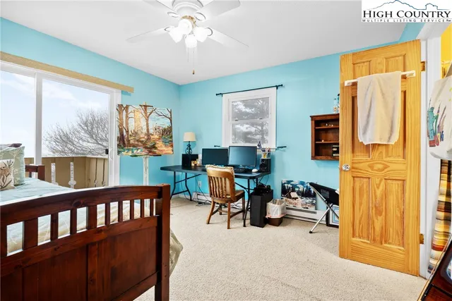 a view of a livingroom with workspace and a window