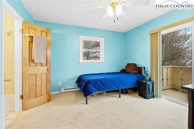 a bed sitting in a spacious bedroom next to a window