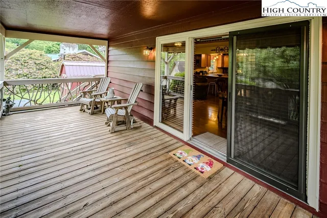 a balcony with chairs and wooden floor