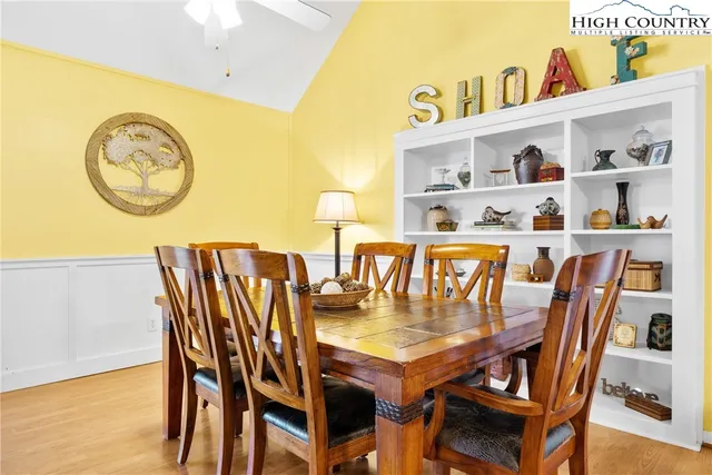 a view of a dining room with furniture and a kitchen