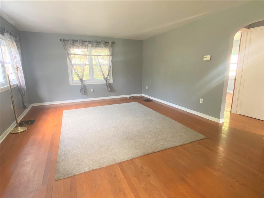 102 Srader Grove Road Freeport, PA 16229 - Photo 7 of 21 an empty room with wooden floor and windows