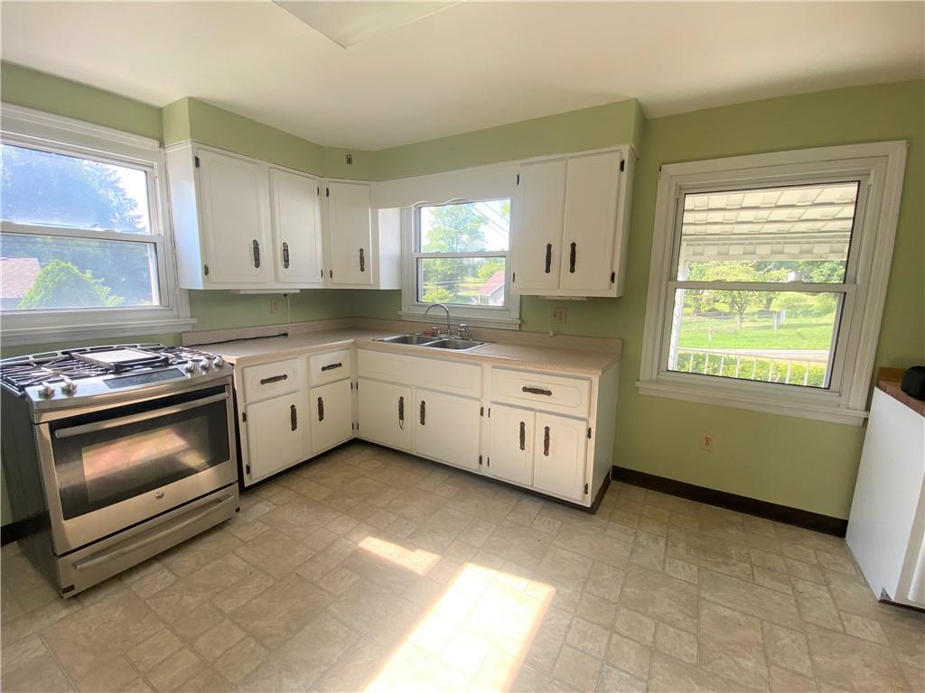 102 Srader Grove Road Freeport, PA 16229 - Photo 8 of 21 a kitchen with a stove a sink and a window