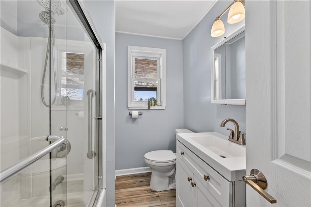19 Locust Lane Upper St. Clair, PA 15241 - Photo 19 of 24 a bathroom with a toilet a sink and mirror