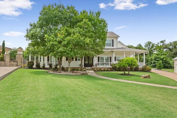 a view of a house with a yard and sitting area