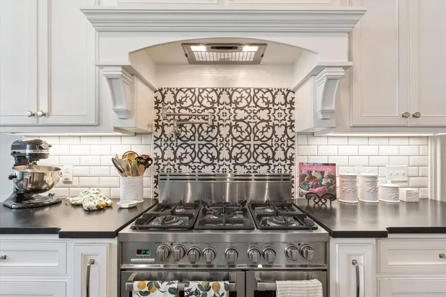 a kitchen with a stove and cabinets