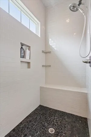 a bathroom with a bathtub and a shower