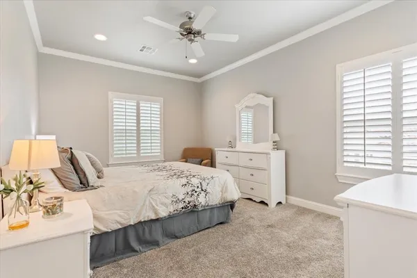 a bedroom with a bed dresser and a window