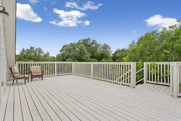 a balcony with view of trees in the background