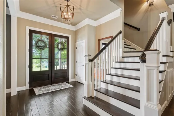a view of entryway with wooden floor and door