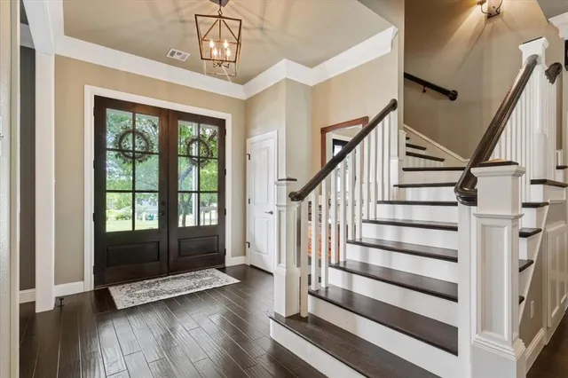 a view of entryway with wooden floor and door