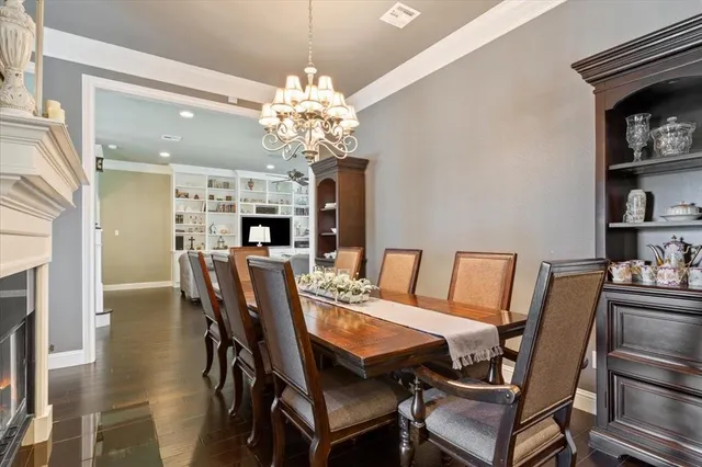 a view of a dining room with furniture and chandelier