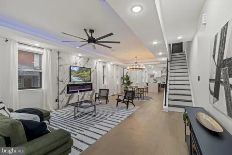 a living room with furniture and a piano