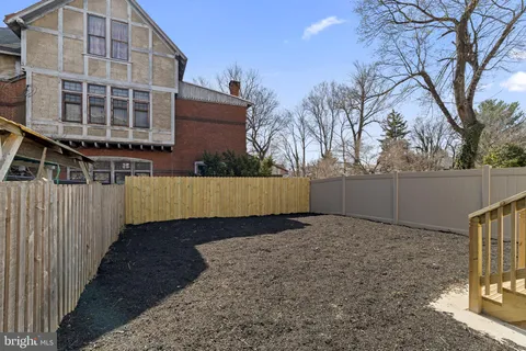 a view of a backyard with a fence