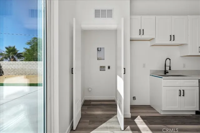 a kitchen with stainless steel appliances granite countertop white refrigerator and white cabinets