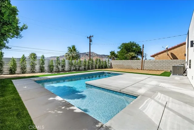 a view of a swimming pool with a yard
