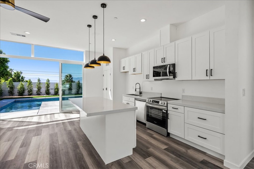66423 San Marcus Road Desert Hot Springs, CA 92240 - Photo 5 of 28 a kitchen with stainless steel appliances granite countertop a stove a sink and a refrigerator