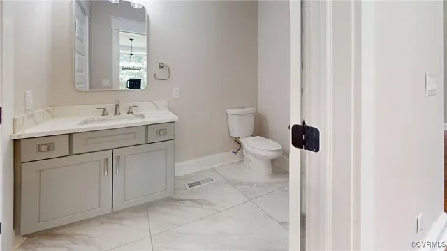 a bathroom with a sink toilet and mirror