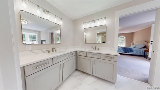a spacious bathroom with a granite countertop sink mirror and