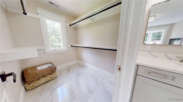 a view of hallway with window and a couch