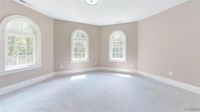 an empty room with windows mirror and windows