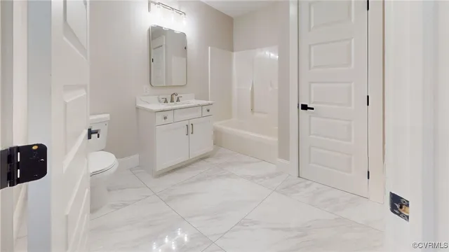 a spacious bathroom with a sink a mirror a toilet and bathtub