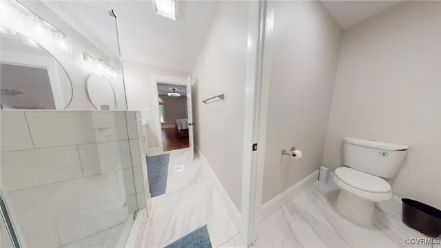 a bathroom with a toilet and a shower