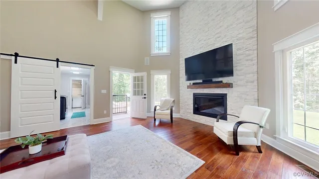 a living room with furniture fireplace and flat screen tv