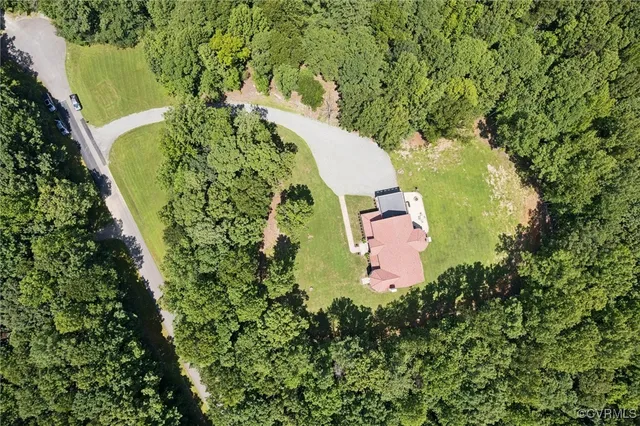 an aerial view of a house with a yard swimming pool outdoor seating and yard