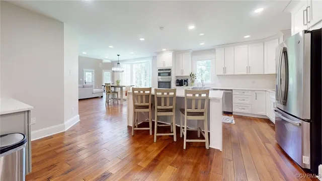 a dining room with furniture and wooden floor