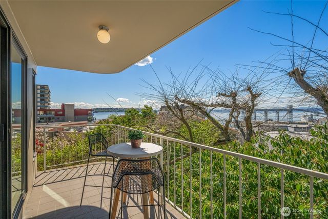 a view of a balcony with table and chairs