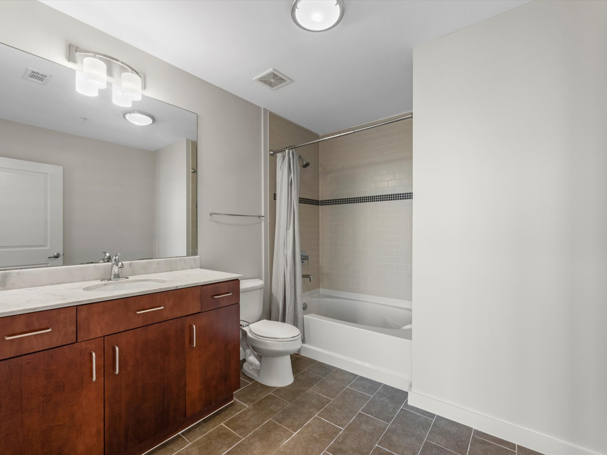 5925 Almeda Road, Unit 11702 Houston, TX 77004 - Photo 16 of 35 a bathroom with a double vanity sink mirror and toilet
