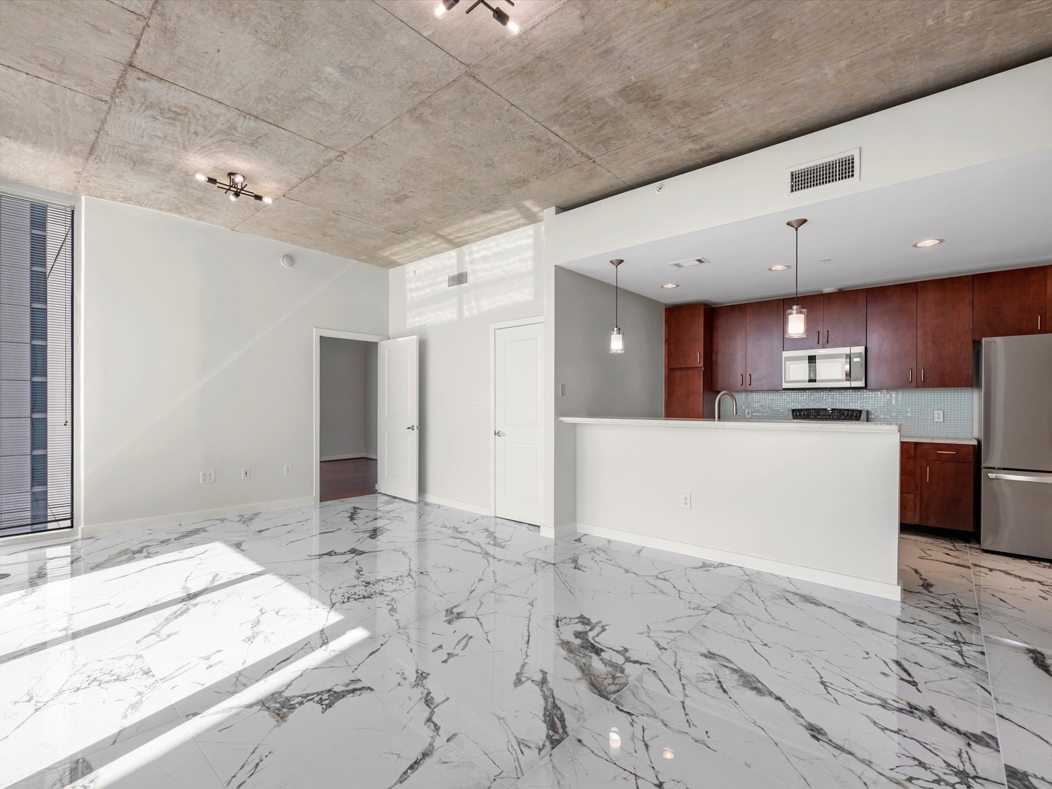 5925 Almeda Road, Unit 11702 Houston, TX 77004 - Photo 3 of 35 a large kitchen with kitchen island a sink stainless steel appliances and cabinets
