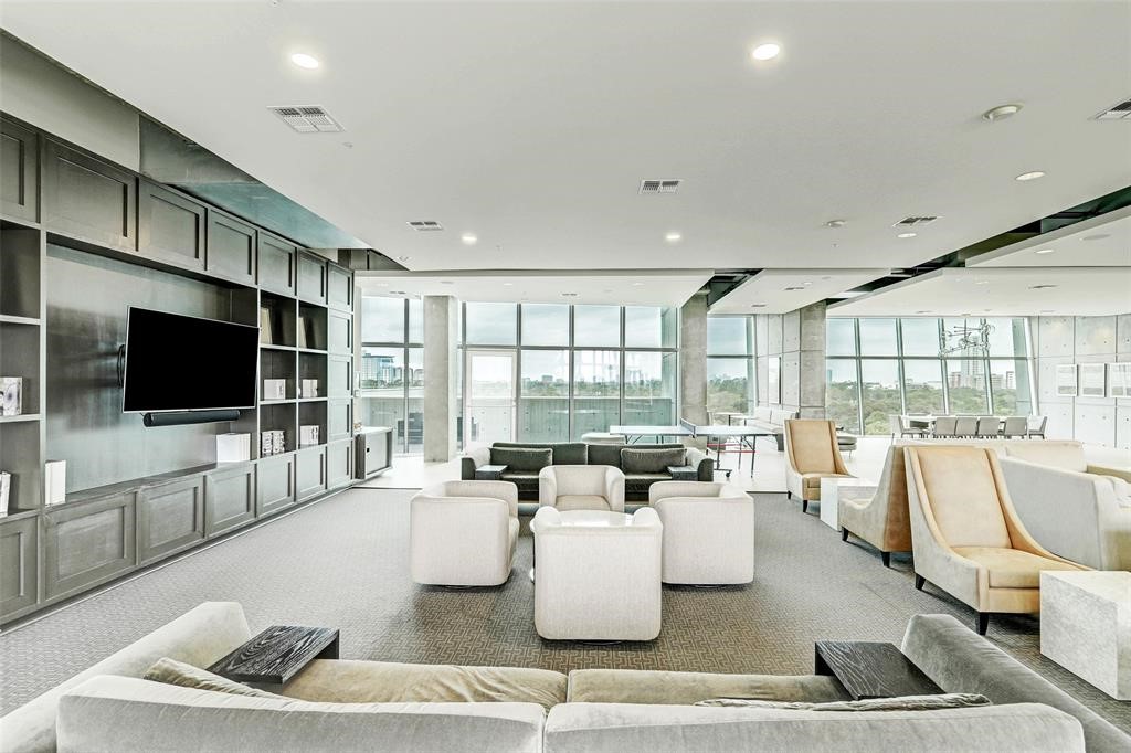 5925 Almeda Road, Unit 11702 Houston, TX 77004 - Photo 32 of 35 a living room with couches and a flat screen tv