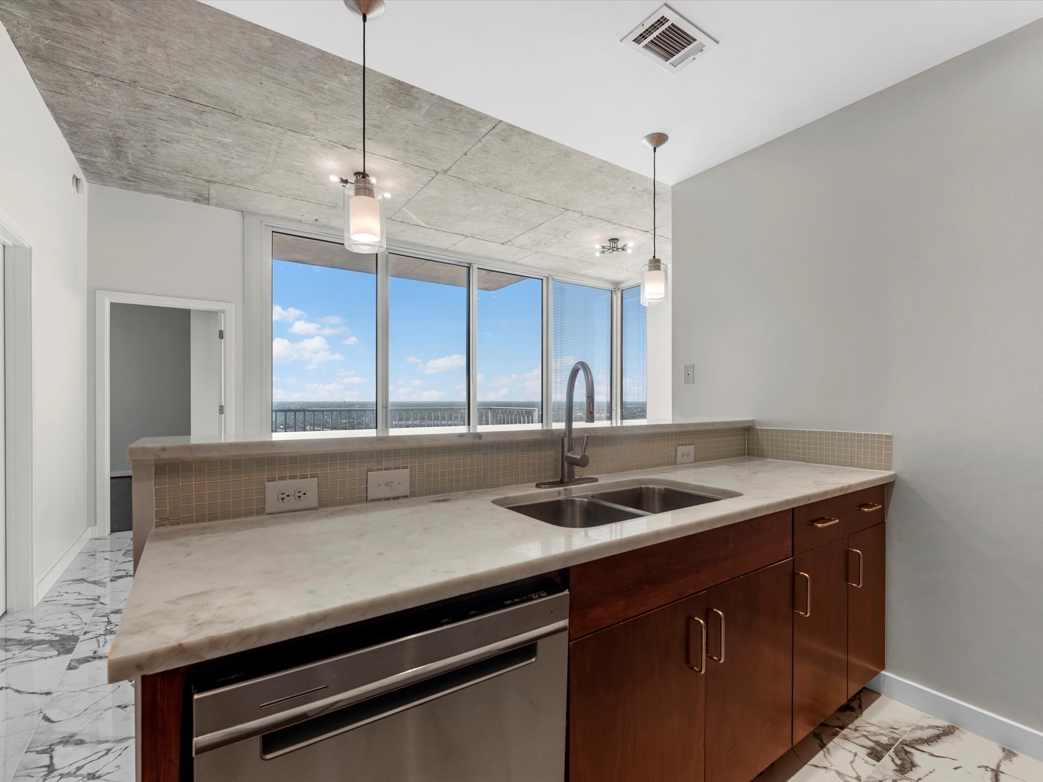 5925 Almeda Road, Unit 11702 Houston, TX 77004 - Photo 7 of 35 a kitchen with a sink a counter space and cabinets