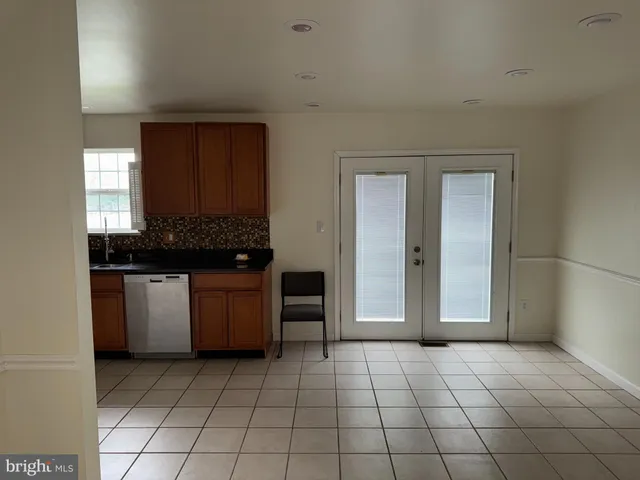 a view of a utility room with closet and windows