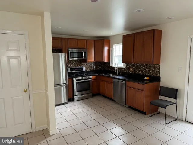 a kitchen with stainless steel appliances granite countertop a sink and cabinets