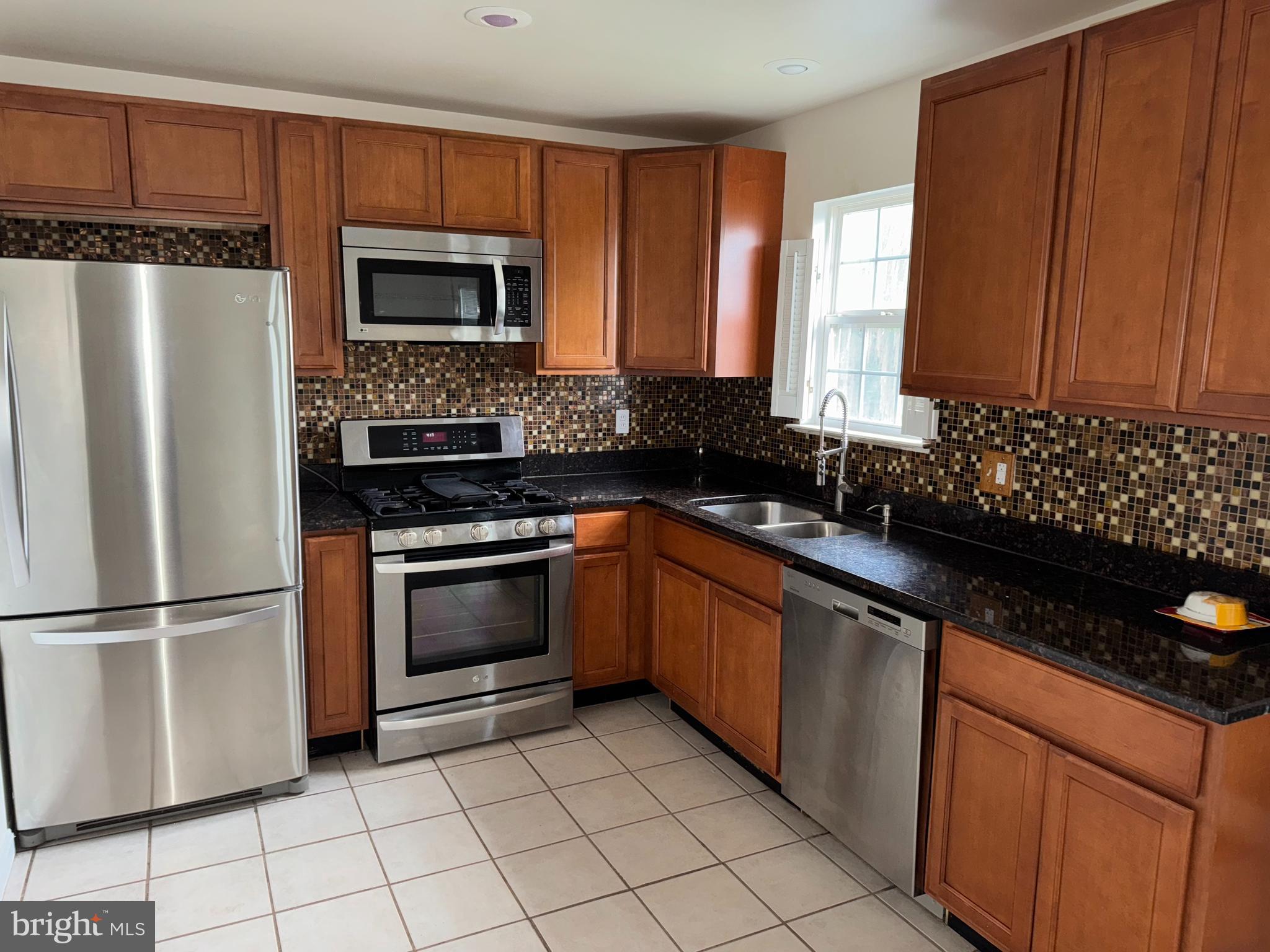 546 Barley Court Smyrna, DE 19977 - Photo 5 of 19 a kitchen with granite countertop a refrigerator stove and sink