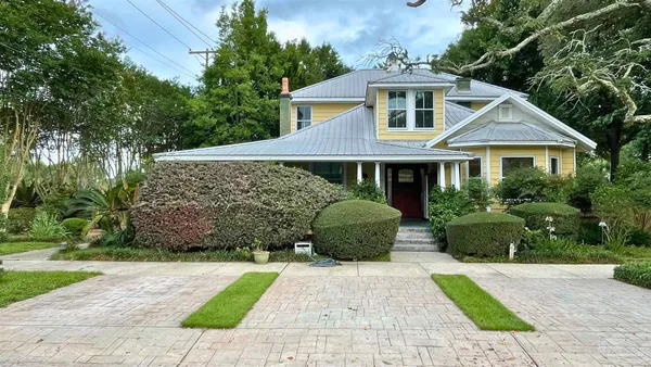 a front view of a house with a garden