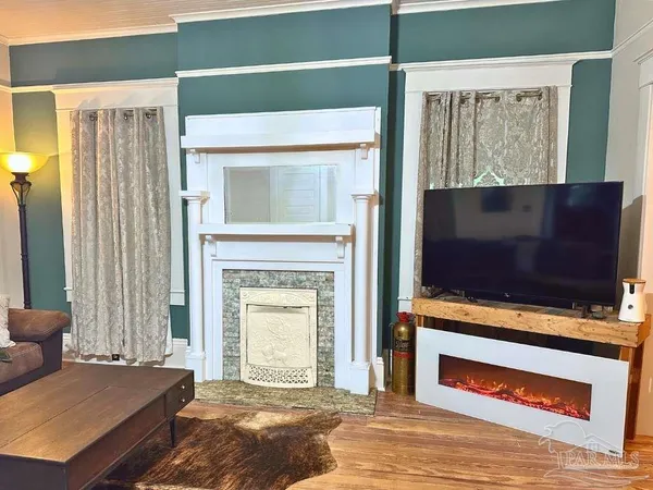 a living room with a fireplace and a flat screen tv