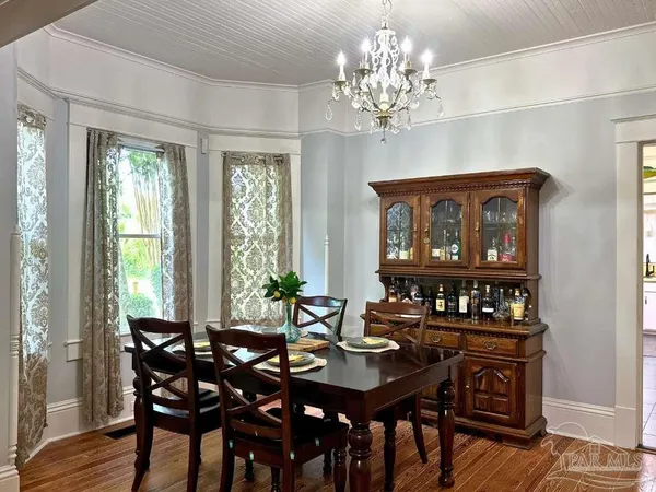 a view of a dining room with furniture window and wooden floor