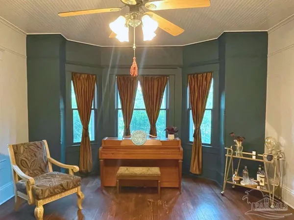 a room with lounge chair and windows