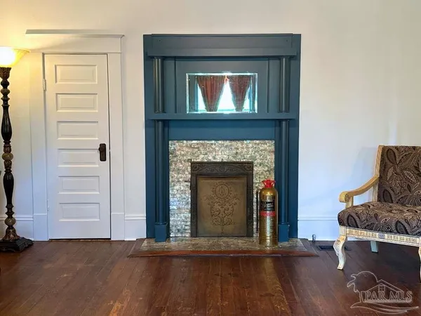 a living room with a fireplace and a wooden floor