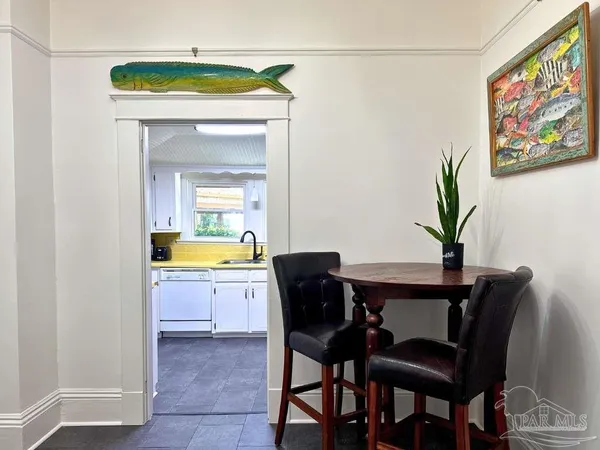 a view of a dining room with a table and chairs