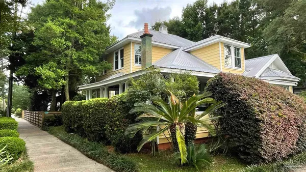 a front view of house with yard and green space
