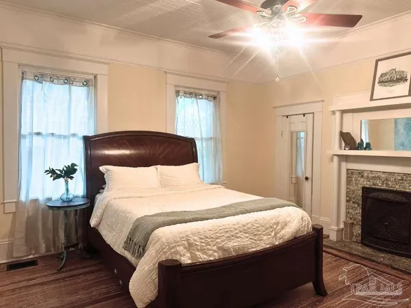 a bedroom with a bed and a fireplace
