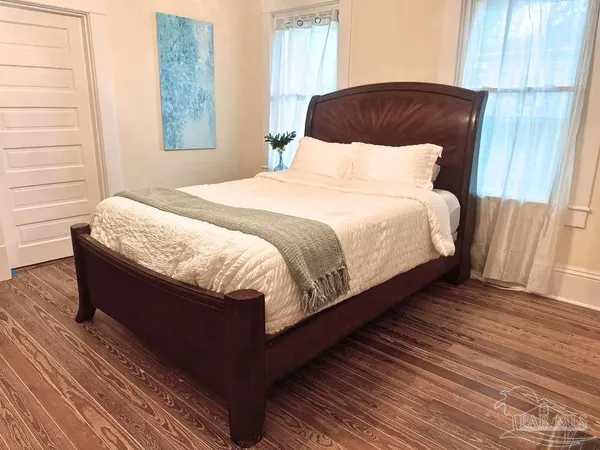 a bedroom with a bed and a window